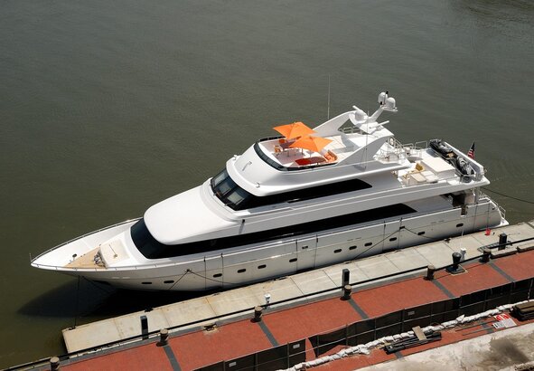 Contratto di charter yacht firmato su un tavolo di teak a bordo